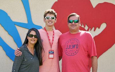 family in from of FAU sign